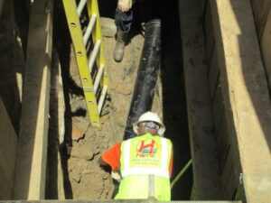 Installing pipe under sidewalk