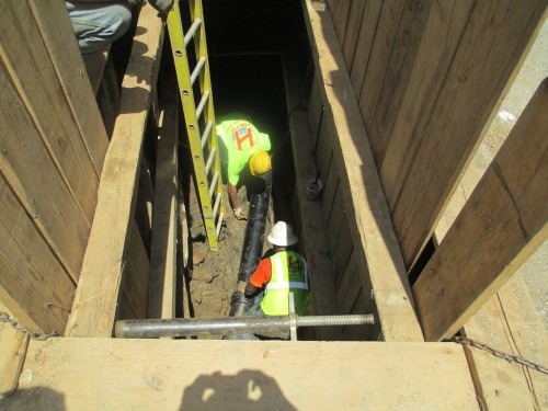 Installing pipe under sidewalk