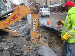 Removing debris in preparation for new pipe