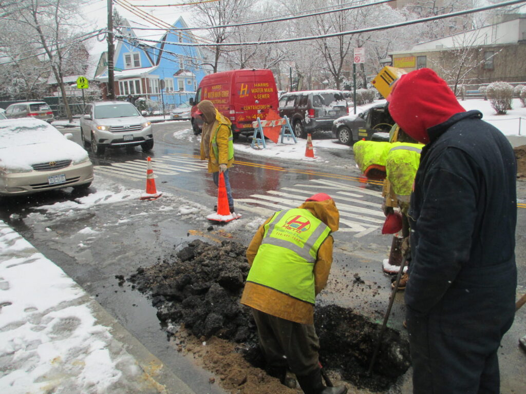 Digging to repair broken water main from cold weather