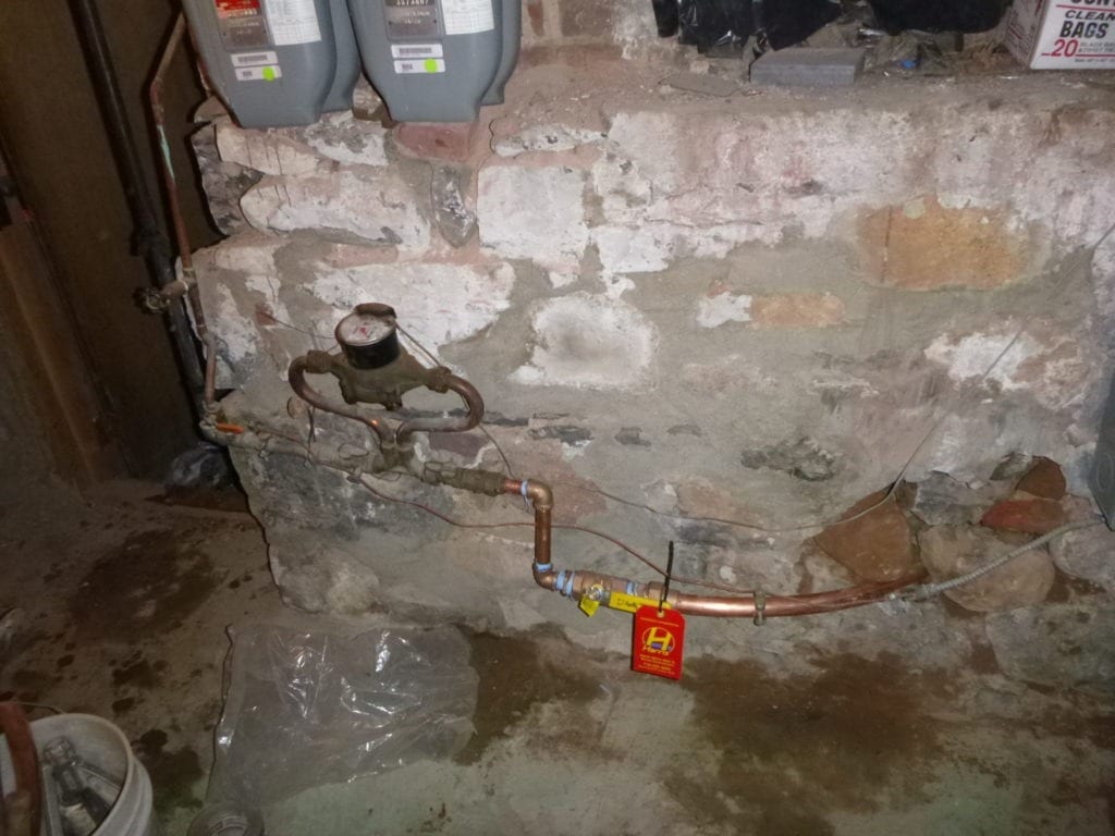 Copper tubing inside foundation wall