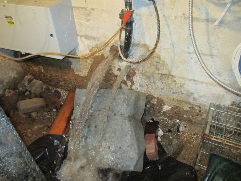 Water main leaks under sidewalk and shows up in house