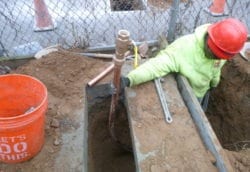 Installing main control valve for copper water main on concrete pad