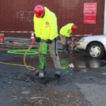 Jackhammer street for water main repair