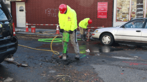 Jackhammer street for water main repair
