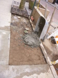 Pouring cement around curb box
