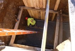 Harris Water Main and Sewer employee assessing a sewer line break