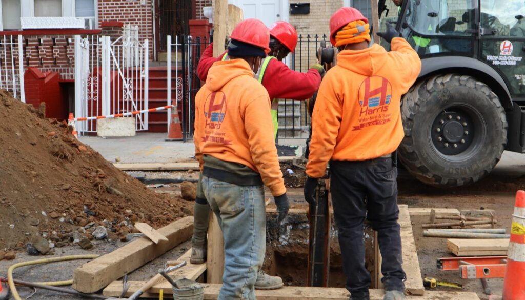 “Technician performing water main repair in Brooklyn”