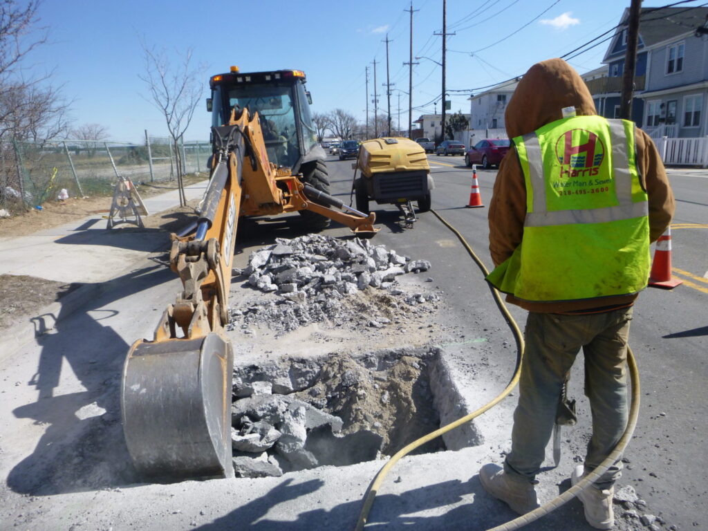Digging for sewer repair in roadway