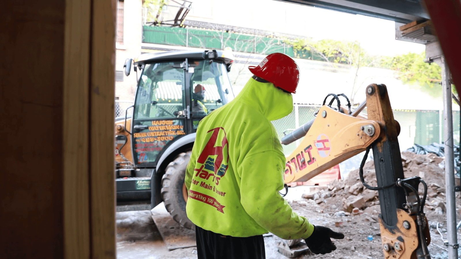 construction-employee-in-yellow-sweatshirt-working-on-sidewalk