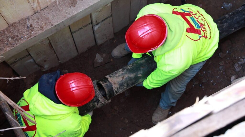 two-men-installing-sewer-line
