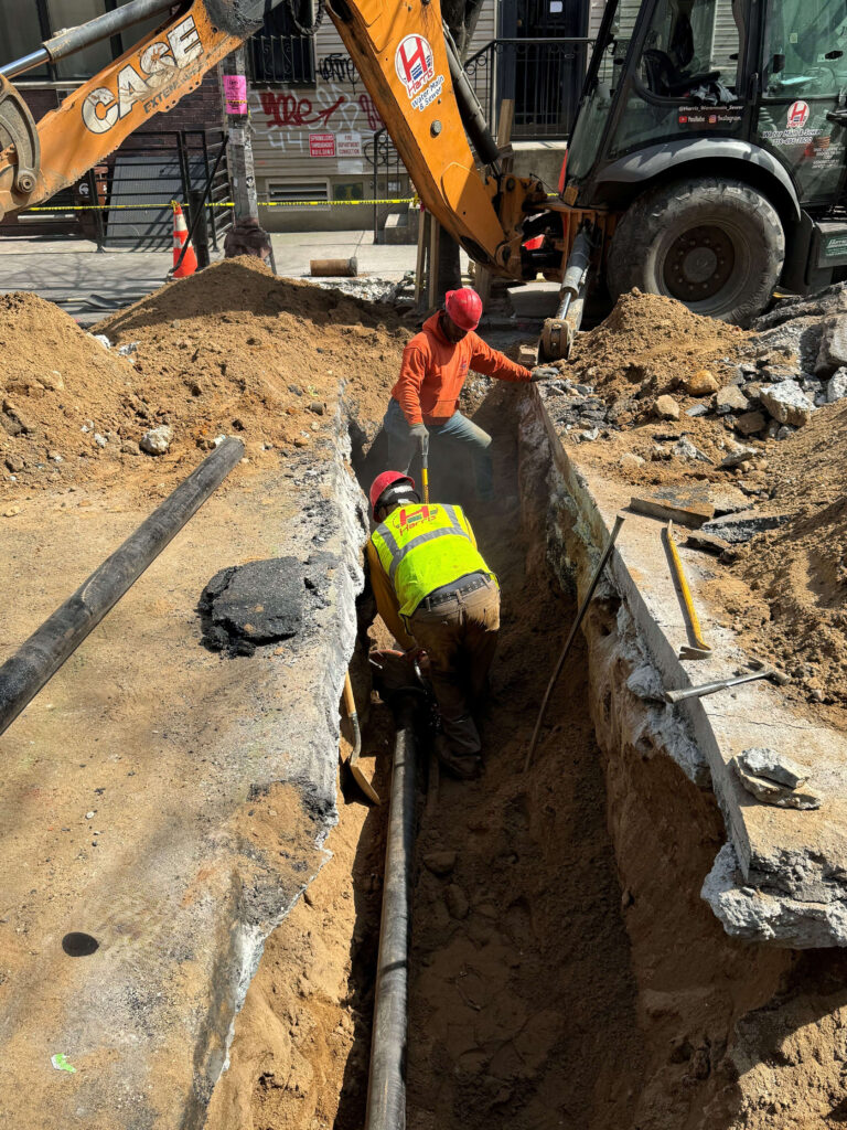 Team operating heavy-duty equipment at local worksite
