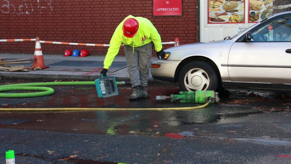 Harris Water Main and Sewer employee using a tap locator